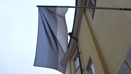Tallinn, Estonia: An Estonian flag flies on a historic building in the Old Town. 
