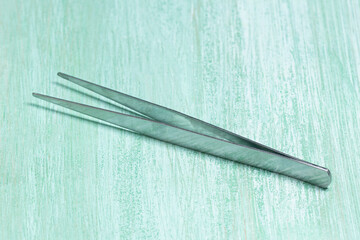 Straight Pointed Tweezers on Mint Background
