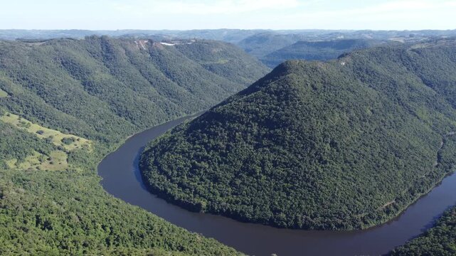 Drone footage of Gelain viewpoint showing the horseshoe bend of Rio das Antas on a bright sunny day, scenic natural landscape in Flores da Cunha, Serra Gaucha, Brazil