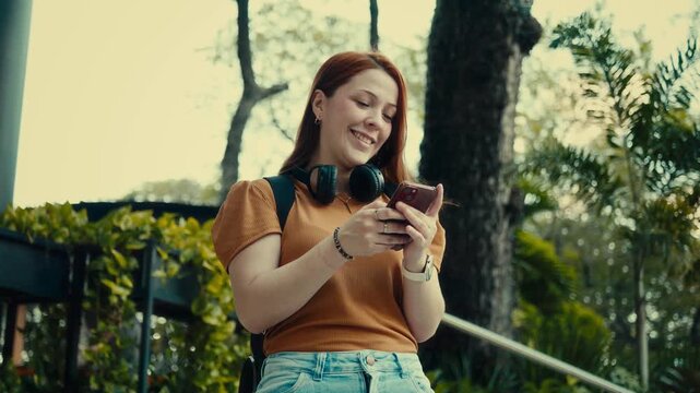 Woman checking messages on smartphone in city