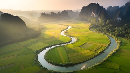 Serene river winds through lush green landscape with majestic mountains