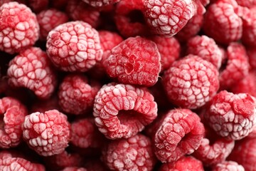 Frozen ripe raspberries as background, above view