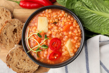 Delicious lentil soup with vegetables served on table, flat lay