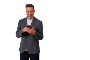 Smiling man standing and engaging with his smartphone, actively typing and reading messages, isolated on transparent background