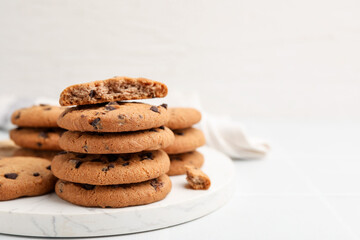 Delicious chocolate chip cookies on light table, closeup. Space for text