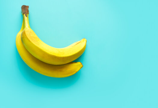 Fresh bananas with vibrant blue background