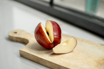 Fresh red apples have been sliced ​​on a wooden cutting board. Red apples. Food photography concept.
