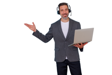 Smiling man wearing headset with microphone, holding laptop, presenting with open hand, on transparent background