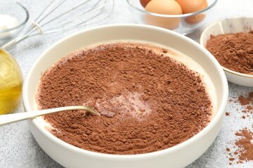 Chocolate dough and ingredients on grey textured table, closeup