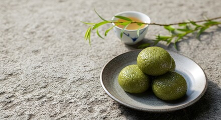 Traditional green Qingtuan food offerings served with delicate tea and a willow branch, embodying the solemn Qingming Festival remembrance concept