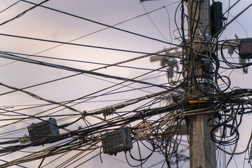 Tangle of electrical wires on a utility pole