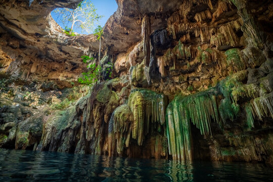 Natural beauty of Tulum Cenote with stalactites and sunlight