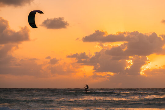 Kitesurfing during a vibrant sunset on Tulum beach