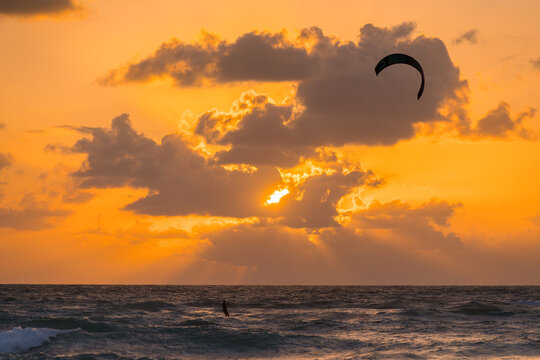 Kitesurfing during a vibrant sunset on Tulum beach