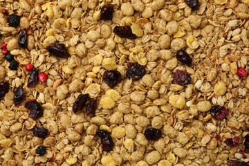 Tasty granola with dried fruits as background, top view