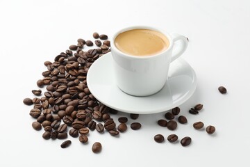 Cup of aromatic coffee and roasted beans on white background