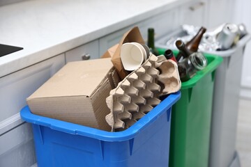 Garbage in trash bins in kitchen, closeup. Waste sorting