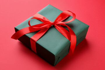 Beautiful gift box on red background, closeup
