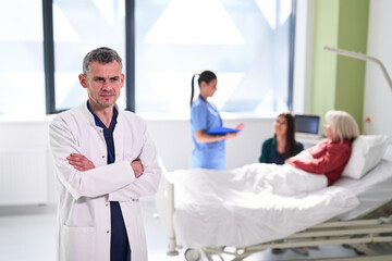 Fototapeta premium Doctor oversees patient care in hospital with nurses providing assistance and support during treatment process