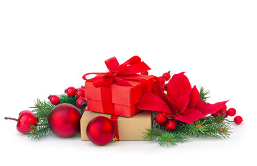 Red Christmas gift boxes with spruce branches, poinsettia flower, berries and baubles on white background with copy space