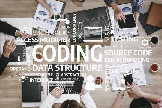 A diverse group of professionals collaborates at a table surrounded by laptops and documents, focusing on coding concepts and programming terminologies. Tessel - Powered by Adobe