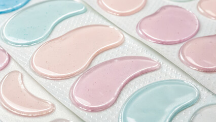 Skincare ritual pattern design. Colorful hydrogel eye patches in soft pastel shades arranged in patterned layout