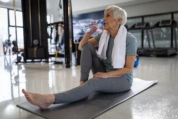 Senior woman rests during gym session