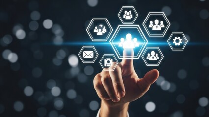 Hand pointing glowing hologram business icons on dark bokeh background
