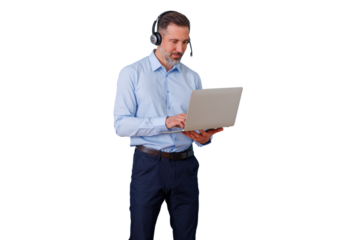 Man in headset standing, typing on laptop, providing customer support, transparent background
