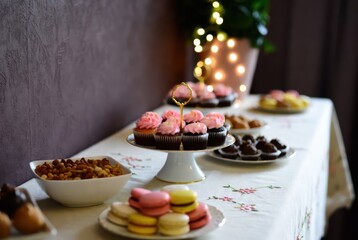 Dessert table with cupcakes and macarons in soft pastel colors