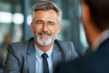 Fototapeta premium portrait of a handsome middle age Caucasian businessman talking with colleague