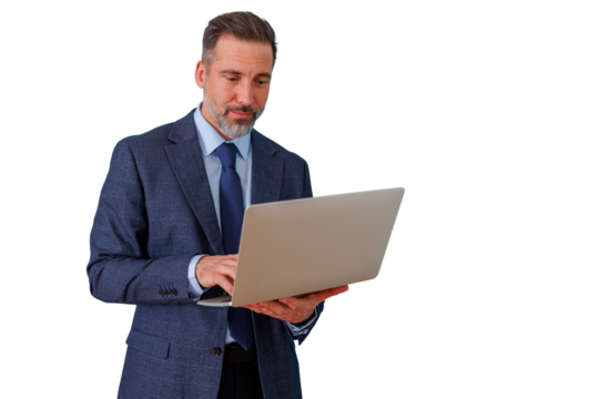 Mature businessman in suit and tie standing, working on laptop, focusing on online business and remote communication - Powered by Adobe