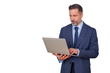 Professional businessman using laptop for work, standing with technology, internet, and corporate communication concept