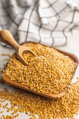 Golden linseed or flaxseed. Healthy flax seed in bowl on kitchen table.