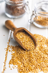 Golden linseed or flaxseed. Healthy flax seed in scoop on white table.