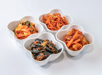 Delicious Korean kimchi side dishes in white flower shaped bowls
