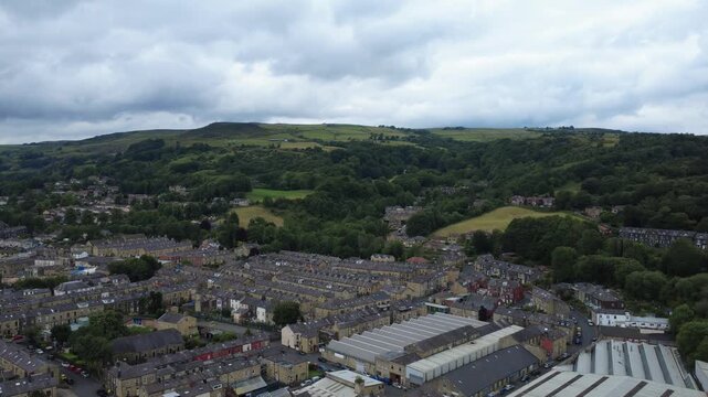 streets of residential houses in Todmorden in West yorkshire next to an industrial area surrounded by hilly Pennine landscape