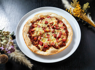Delicious homemade pizza on white plate with flowers