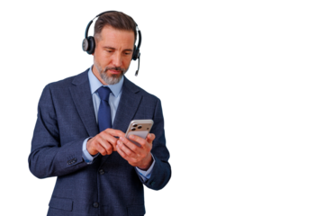 Mature businessman wearing a headset and suit using a smartphone, connecting and communicating with clients, remote work