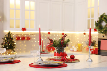 Christmas decor and tableware on white marble table in kitchen. Interior design