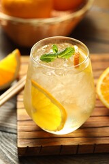 Refreshing spritzer cocktail with mint on wooden table, closeup