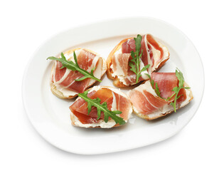 Delicious bruschettas with cream cheese, prosciutto and arugula isolated on white, top view
