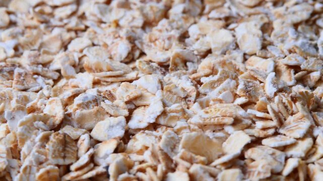 Macro footage of uncooked oatmeal flakes rotating. natural ingredients wholesome food concepts, suitable for diet presentations, fitness branding or content about healthy lifestyle and balanced eating