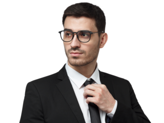 Close-up of a serious young businessman in a black suit and glasses adjusting his necktie