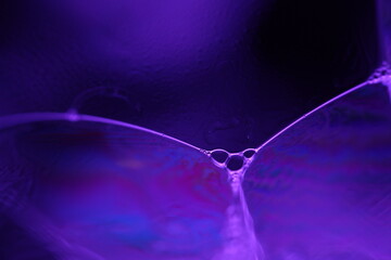 Purple liquid glowing flat film, colourful macro abstraction, interference pattern, glowing elements, smooth motion 