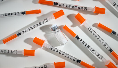 Clear Glass Vials Next to Single Use Syringes