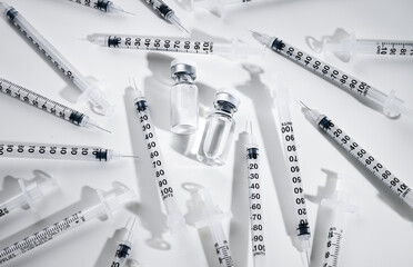 Clear Glass Vials Next to Single Use Syringes