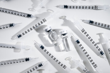 Clear Glass Vials Next to Single Use Syringes