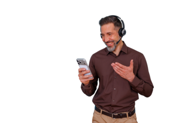 Man wearing a headset using a smartphone for a video call. He is smiling and gesturing, engaging in remote communication