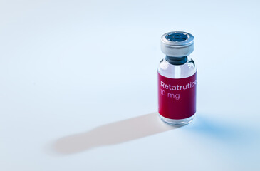 Close up of Retatrutide Glass Vial and Single Use Insulin Syringes